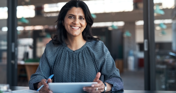 Smiling woman at conference table