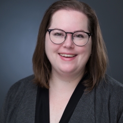 Picture of Sophie McNeil Wolf, wearing glasses smiling